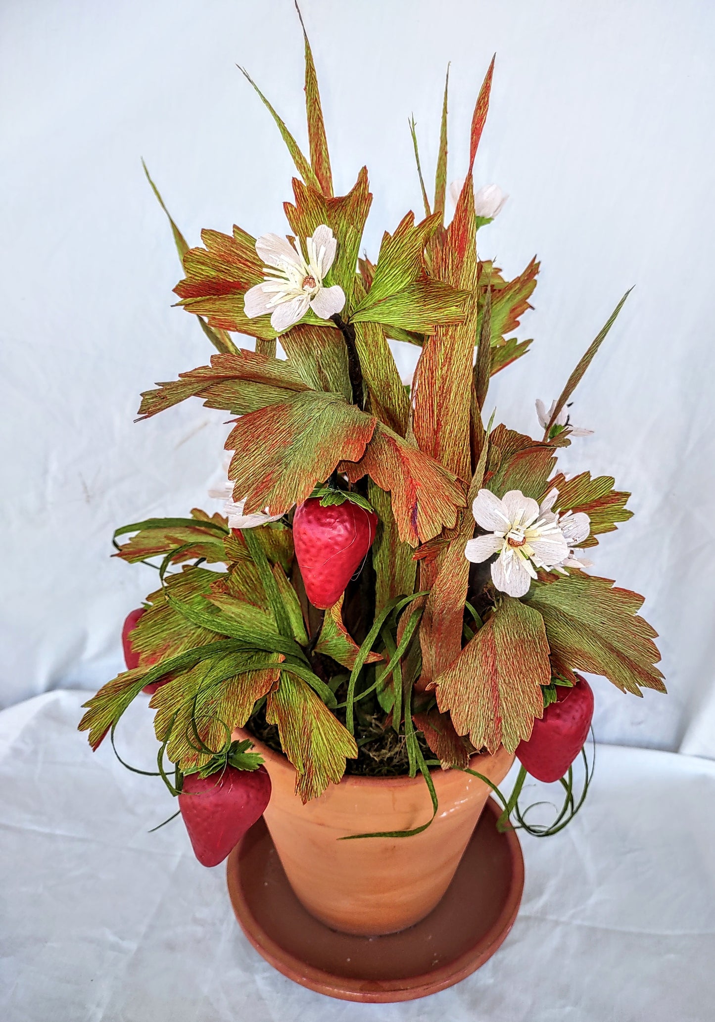 Strawberry lovers bucket full of colorful flowers.