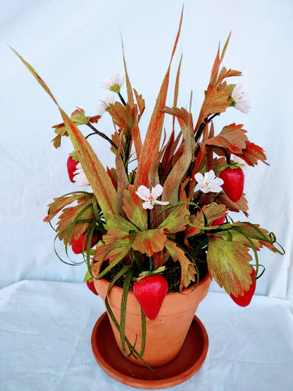 Strawberry lovers bucket full of colorful flowers.