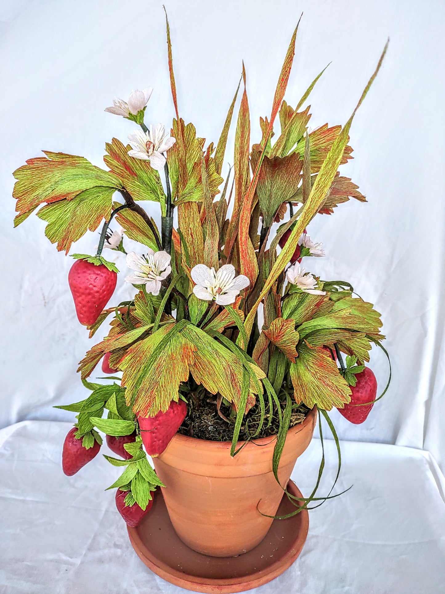 Strawberry lovers bucket full of colorful flowers.