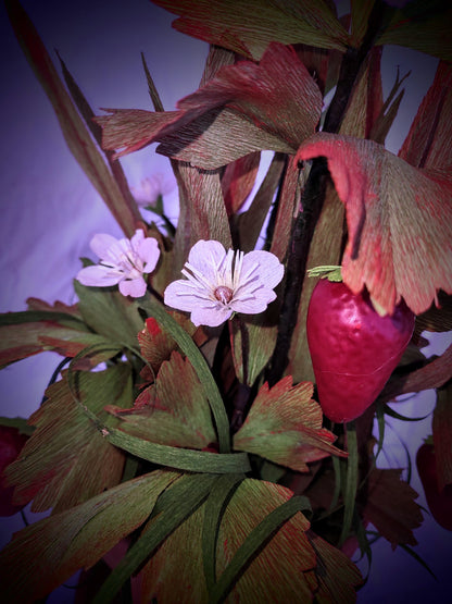 Strawberry lovers bucket full of colorful flowers.