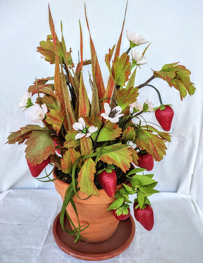 Strawberry lovers bucket full of colorful flowers.